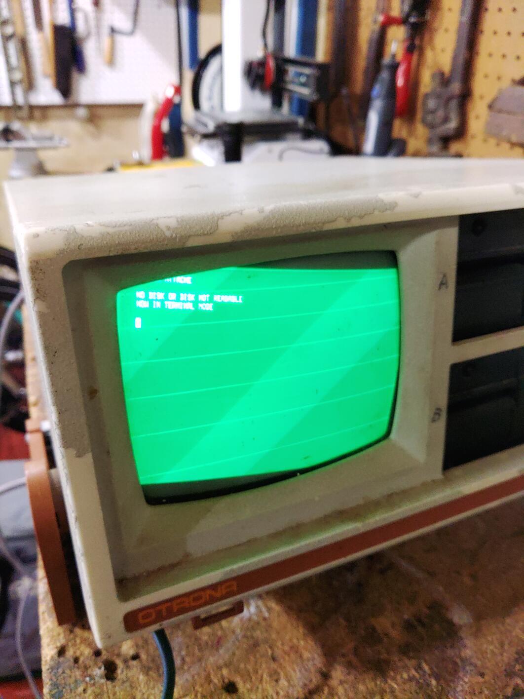 a close up of the Attache's CRT display showing inverted colors and the image out of alignment